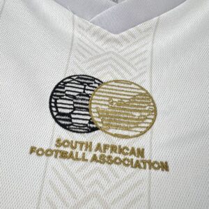 Camiseta Sudáfrica 2010 Pre-Partido Blanca - detalle material y patrón